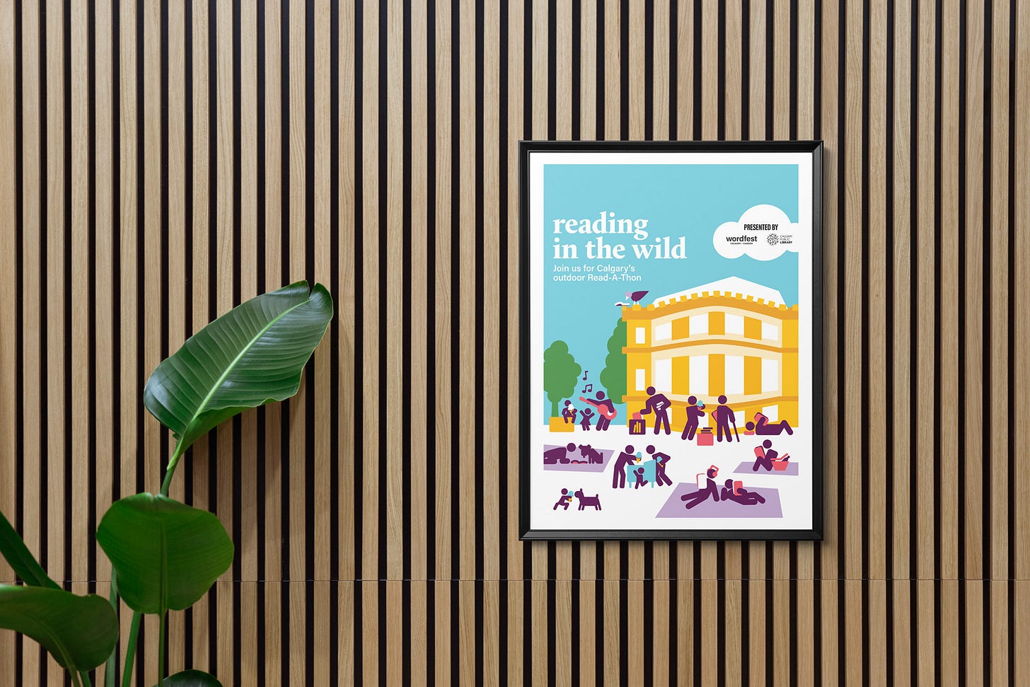 Photo mockup of a poster illustration in a fram hanging on a wooden panelled wall. The illustration depicts people reading in a park in front of a sandstone building with a poster title that reads Reading in the Wild