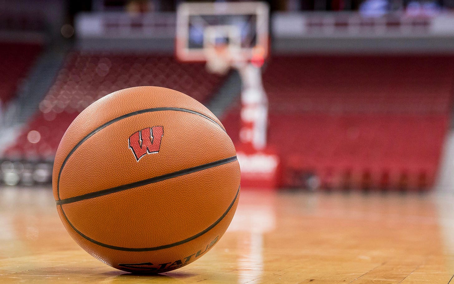 A Wisconsin Badgers basketball rests on the court inside the Kohl Center