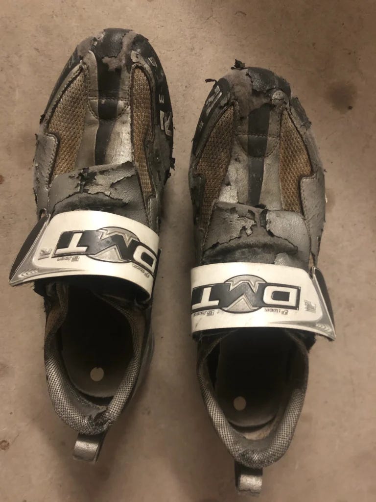 well-worn, silver triathlon cycling shoes