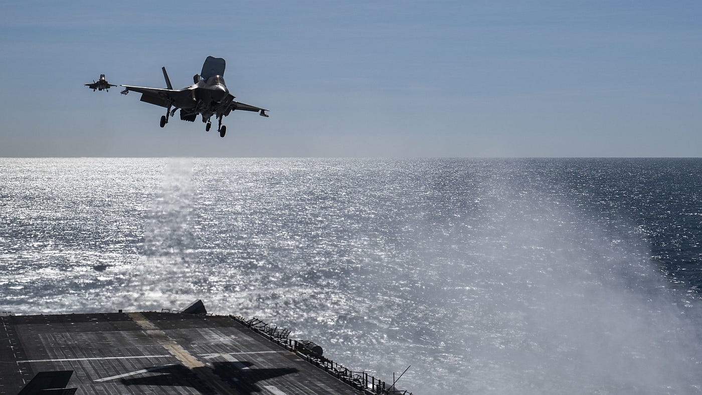Two F35s landing on an aircraft carrier deck Two F35s landing on an aircraft carrier deck