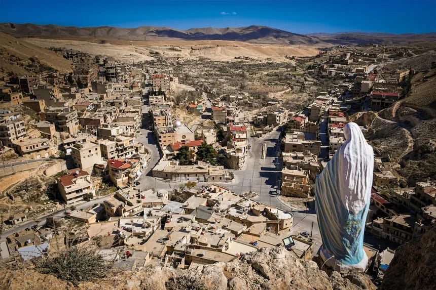 The statue of the Virgin Mary, titled “Lady of Peace” — Sayyidat as-Salām — rises over the ancient Christian town of Maaloula, Syria, one of the last places on earth where Aramaic, the language of Jesus, still survives in living memory.