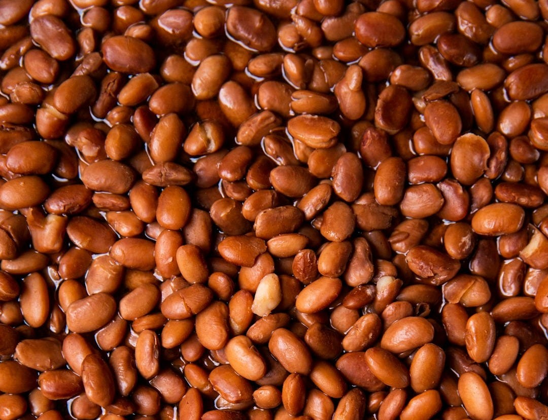 brown coffee beans on brown wooden surface