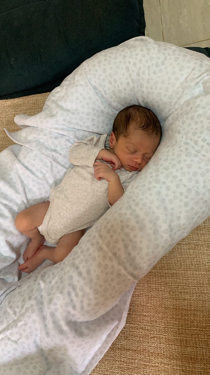 Picture o baby Levi and pciture.  Photo of Renato with hospital hairnet and Levi laying next to Ingrid's head surrounded by the hospital bed.