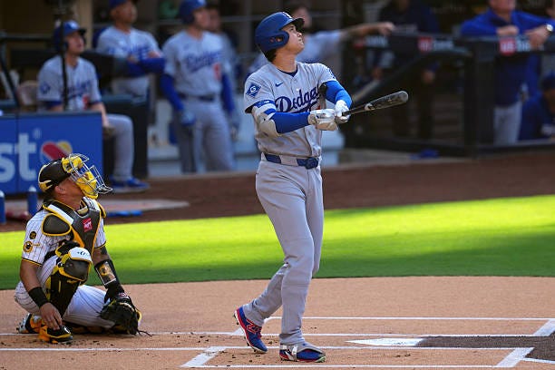Shohei Ohtani of the Los Angeles Dodgers hits a solo home run in the first inning during the game between the Los Angeles Dodgers and the San Diego...