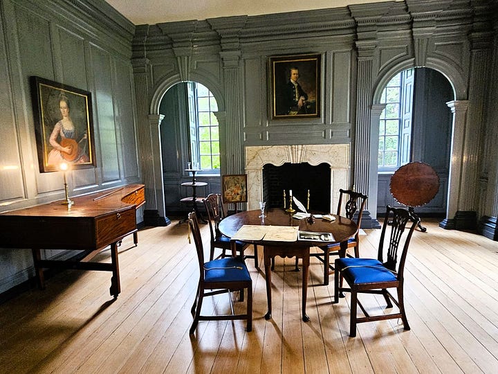 Colonial rooms with walls painted blue and wooden floors.