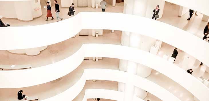 Photo inside an office building showing several floors from the atrium.