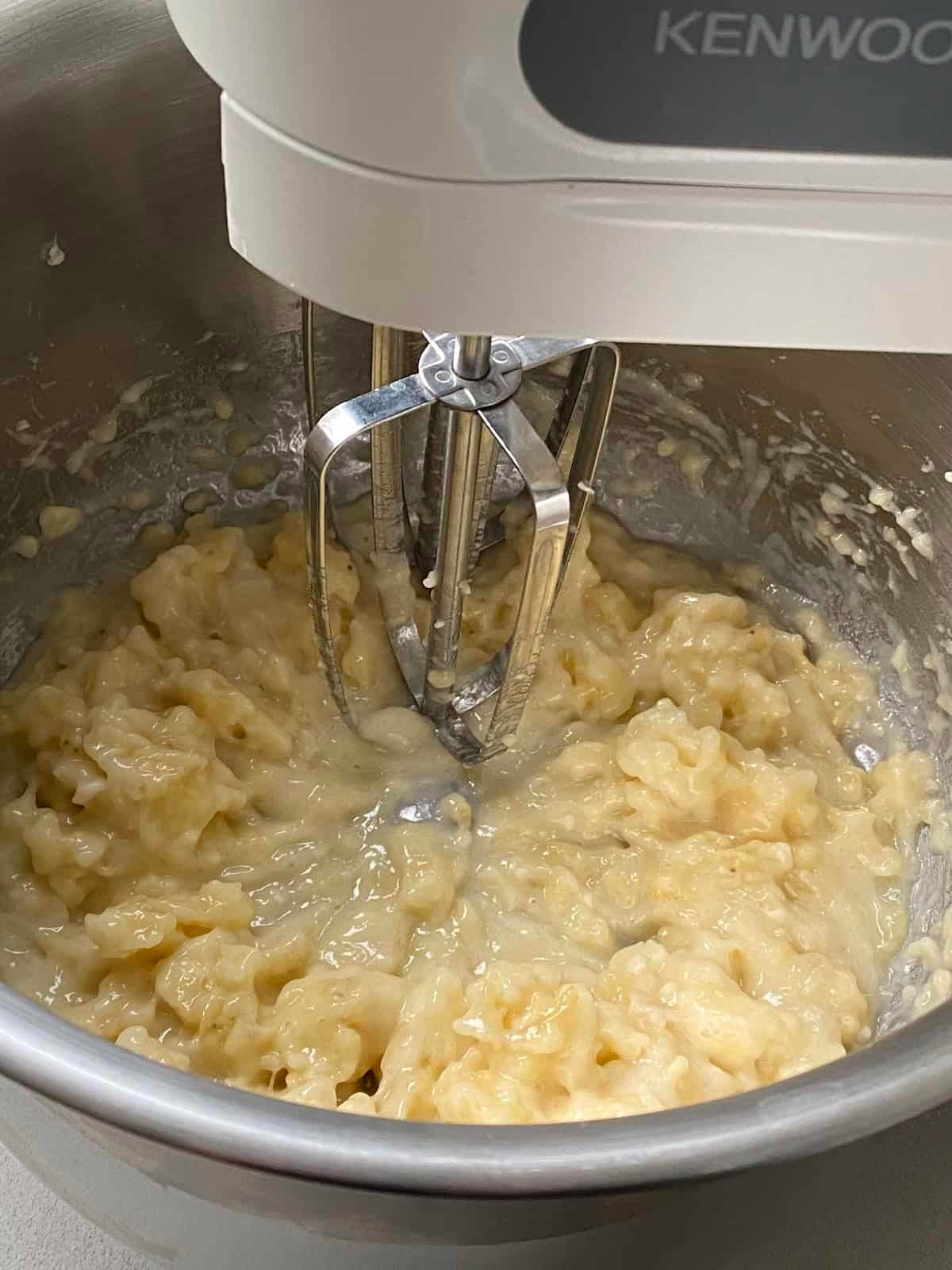 Mash the bananas in a small electric mixer.