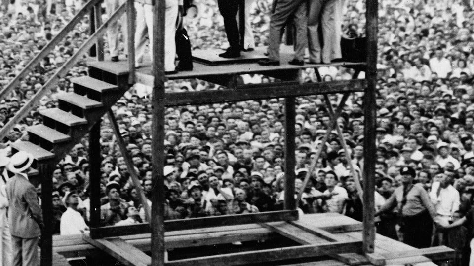 A crowd of approximately 20,000 people gather to witness the public hanging of Rainey Bethea in Owensboro, Kentucky, on August 14, 1936.