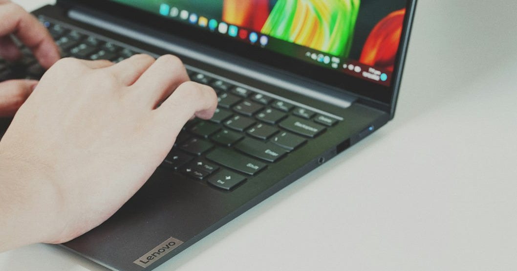 Person typing on a laptop keyboard Person typing on a laptop keyboard
