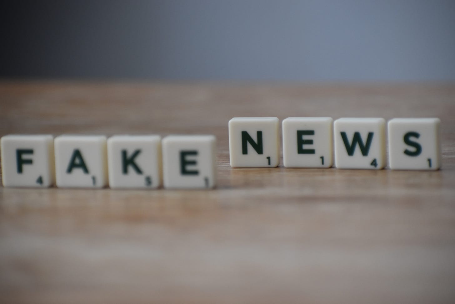 the words Fake News spelled out in scrabble tiles. 