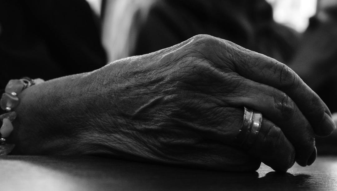 a close up of a person's hands resting on a table
