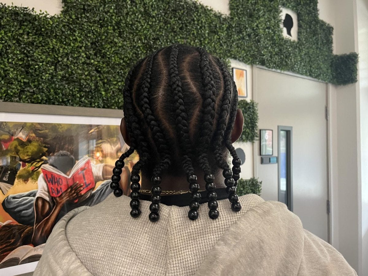 Anthony Fulcher, 23, mechanical engineering, cyber security and accounting major, shows off his braids. Fulcher said black hair can do things that other hair can’t do because it's so versatile. (Savannah Anderson | The Union)