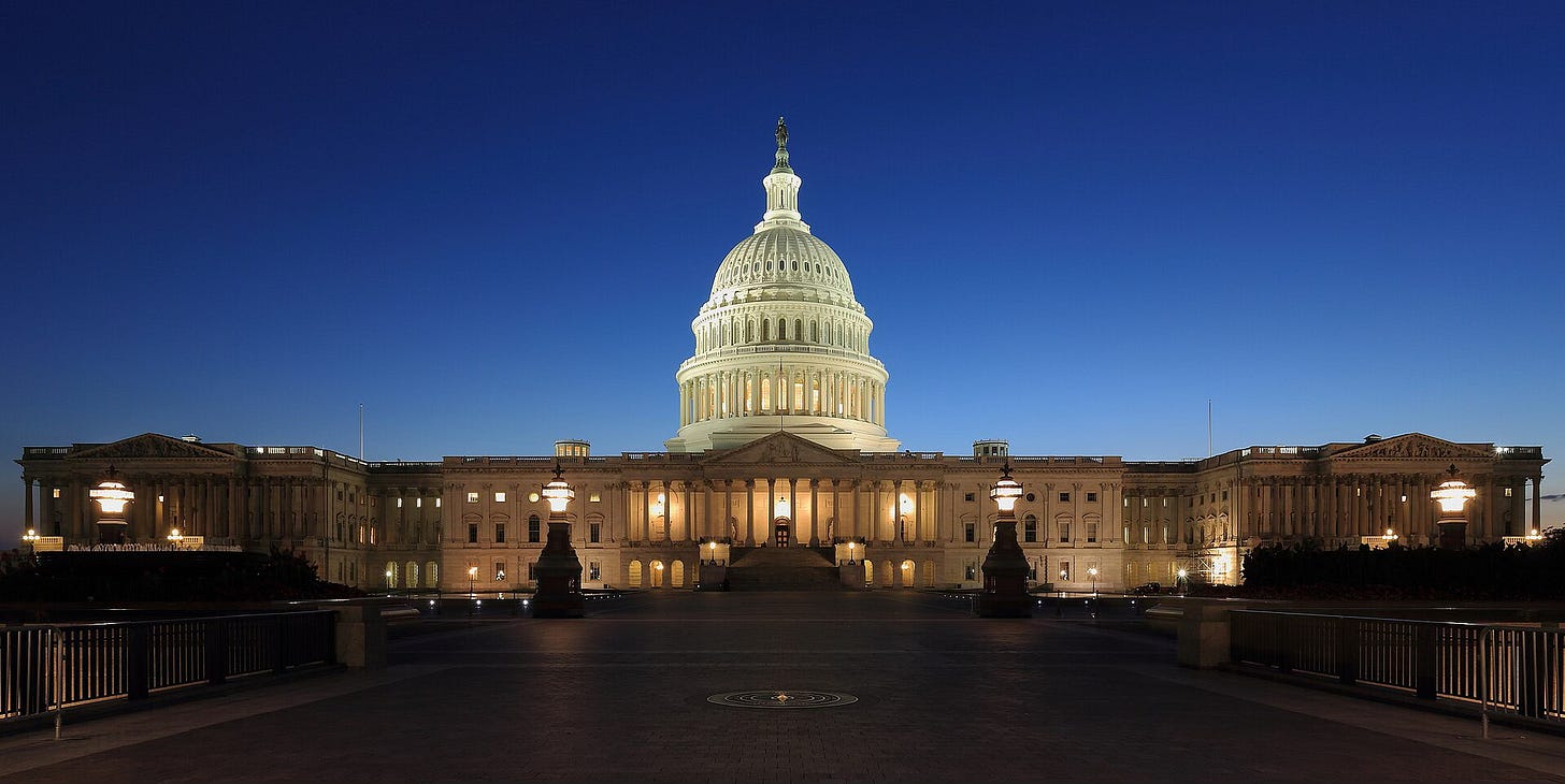 The United States Capitol illuminated at dusk, seen from the eastern side under a deep blue evening sky. The United States Capitol illuminated at dusk, seen from the eastern side under a deep blue evening sky.