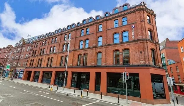 The redbrick outer facade of the Premier Inn where George's St meets Stephen St. 
