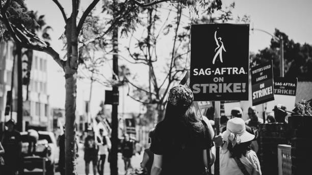 SAG-AFTRA & WGA Actors join writers at the picket lines in Los Angeles at the entertainment strike On July 14, 2023, a historic event unfolded as members of the esteemed Hollywood actors' union, SAG-AFTRA, stood shoulder to shoulder with screenwriters, forming a resolute picket line outside Amazon Studios in Los Angeles, California. This marked the commencement of an actors' strike, representing a significant milestone in the entertainment industry. Notably, SAG-AFTRA, renowned for advocating the rights of actors and other media professionals, joined forces with the Writers Guild of America (WGA) workers, who had been engaged in a determined strike against the Hollywood studios for three months.

This joint walkout, a rare occurrence not witnessed since 1960, underscores the magnitude of the situation. The collaboration between SAG-AFTRA and WGA intensifies the impact of the strike, with the potential to bring Hollywood productions to a complete standstill. As writers persist in their ongoing protest against the studios, the addition of actors amplifies their collective voice, bolstering the strength of their demands.

This development is poised to disrupt the intricate ecosystem of filmmaking, as both actors and writers play vital roles in the creative process. The repercussions of this unified stand reverberate throughout the industry, posing formidable challenges to the production of films and television shows. sag-aftra stock pictures, royalty-free photos & images