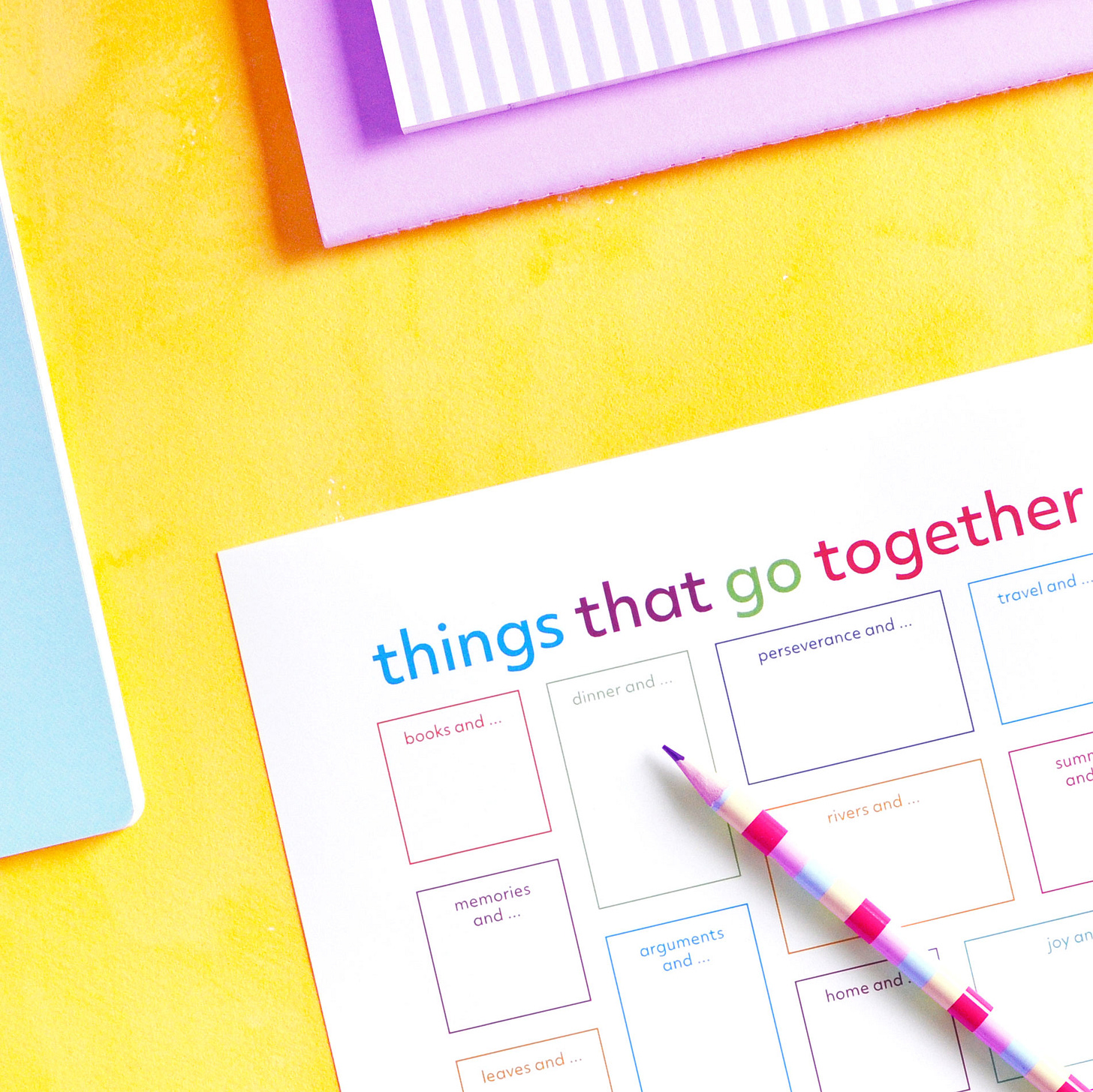 Colourful journal page titled Things That Go Together on yellow background shown with colourful pencil and notebooks.