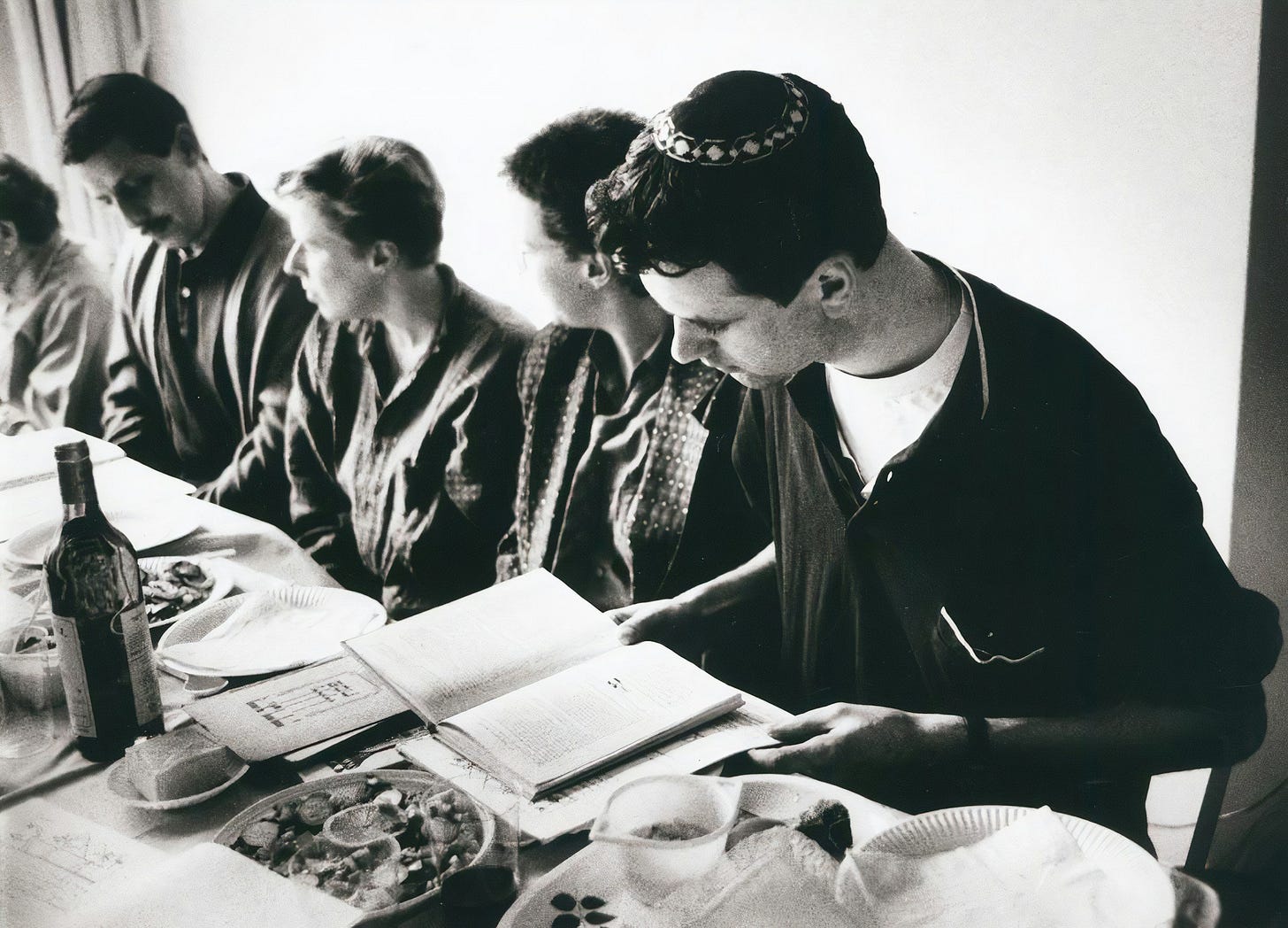 people sitting at a seder table