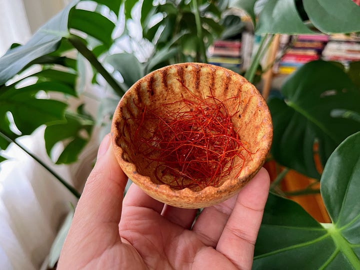 A salad with chili threads on it, a bowl of chili threads
