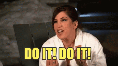 Animated GIF of a woman in a white robe leaning forward and shouting enthusiastically while text on the screen flashes “DO IT! DO IT!” in large yellow letters.