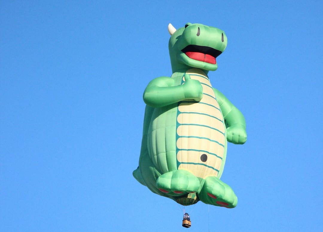 green frog with blue and white polka dot scarf