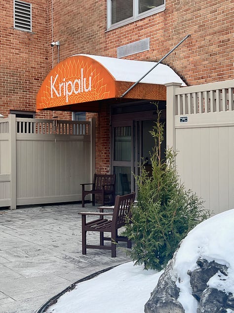 Kripalu's entrance, the lobby, a selfie of Kelsey in the elevator with the campus map, the sign to the healing arts waiting room, and a quote by W.E.B DuBois on the wall of the stairwell stating "Be ready at any moment to give up what you ae for what you might become."