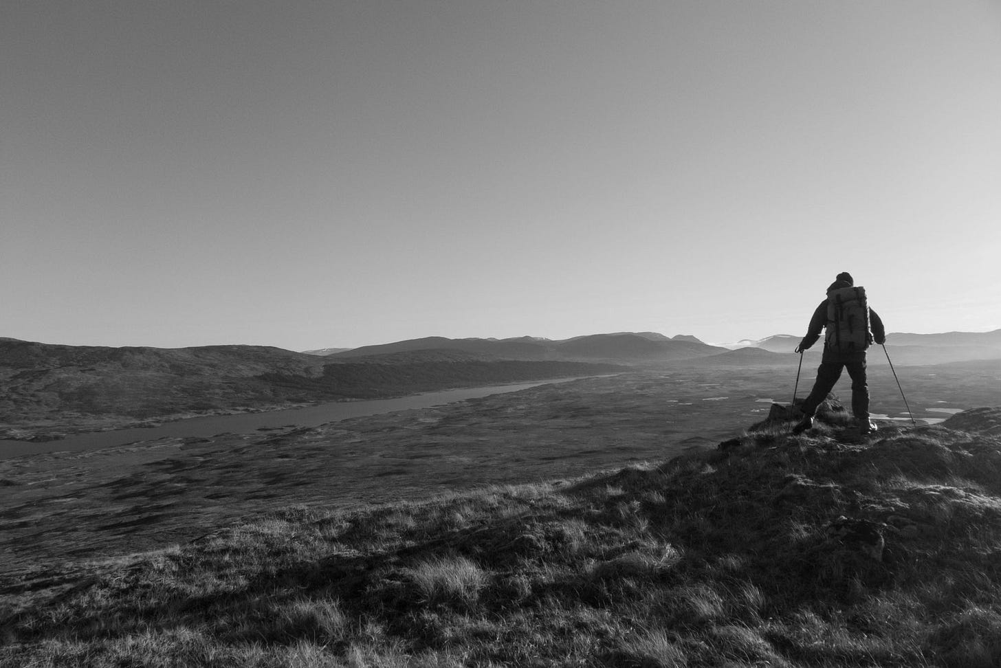 walker above moorland with lake