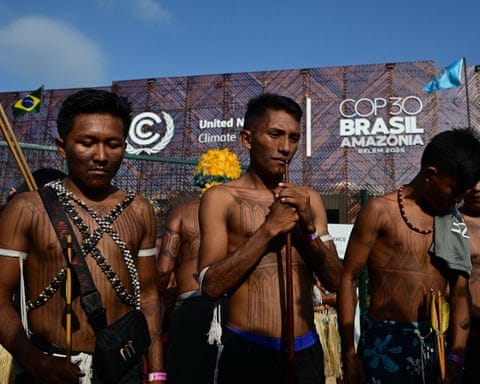 Indigenous people from the Munduruku group stage a protest against infrastructure projects they believe threaten their land at the Cop30 entrance.