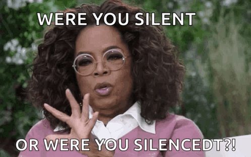 a woman wearing glasses and a pink shirt says " were you silent or were you silenced ? " a woman wearing glasses and a pink shirt says " were you silent or were you silenced ? "