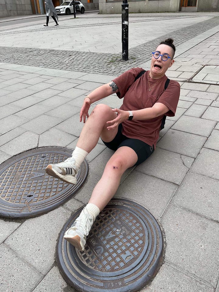 Two images of Shell dramatically posing on the ground as if they had just fallen and tripped over a manhole cover