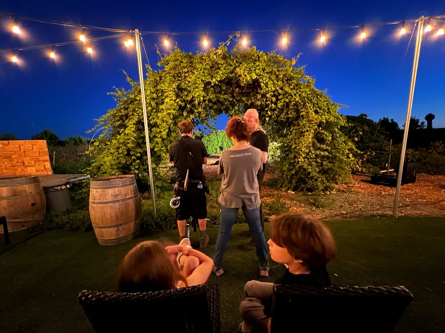 Two children watch on the set of The Not while director Courtney Hoskins speaks with the crew.