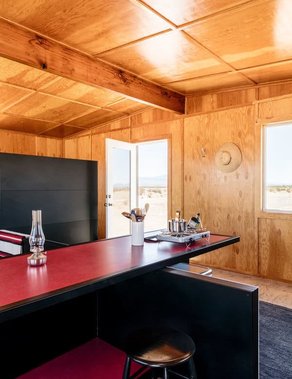 The eating and cooking areas in Zittel’s "Experimental Living Cabin." Tucked beneath the propane stove is a cooler for storing food.