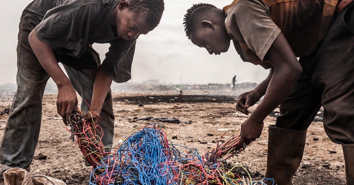 Boys moving scrap, including computers keyboards and other e-waste, at the former Agbogbloshie dump in Ghana in March 2009. Photo by Andrew McConnell/Panos Boys moving scrap, including computers keyboards and other e-waste, at the former Agbogbloshie dump in Ghana in March 2009. Photo by Andrew McConnell/Panos