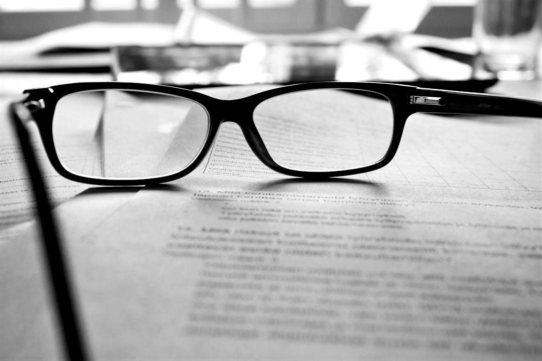 black-framed eyeglasses on white printing paper black-framed eyeglasses on white printing paper