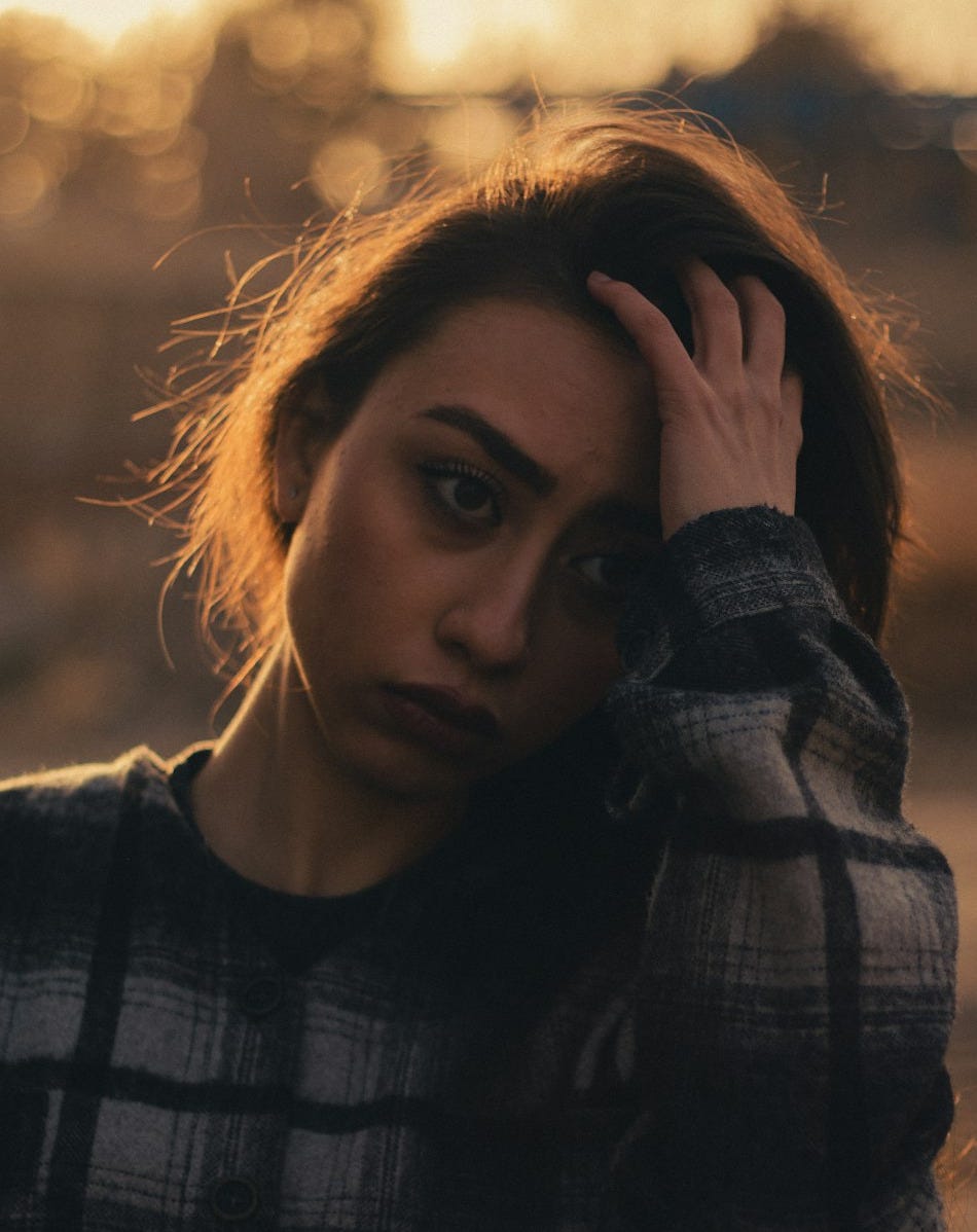 a woman with her hand on her head