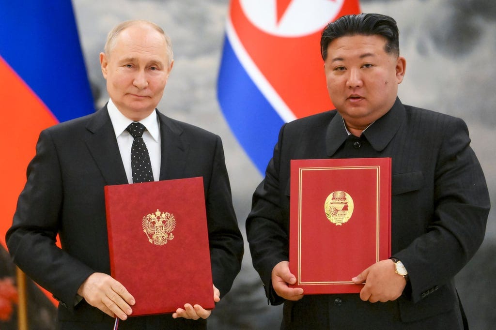 Russian President Vladimir Putin (left) and North Korean leader Kim Jong-un pose for a photo during the signing ceremony in June last year. Photo: Sputnik via AP Russian President Vladimir Putin (left) and North Korean leader Kim Jong-un pose for a photo during the signing ceremony in June last year. Photo: Sputnik via AP
