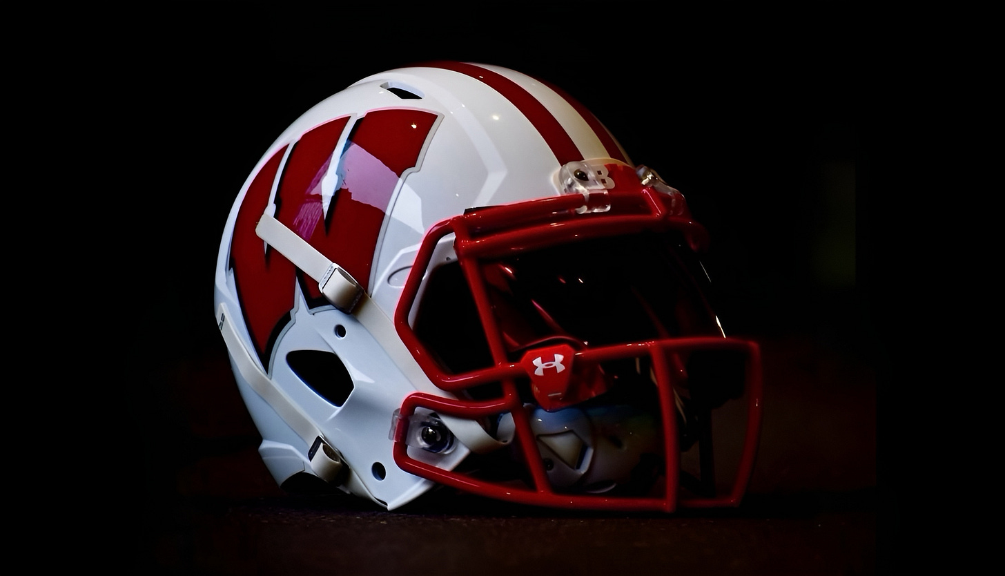Wisconsin Badgers football helmet on a black background.