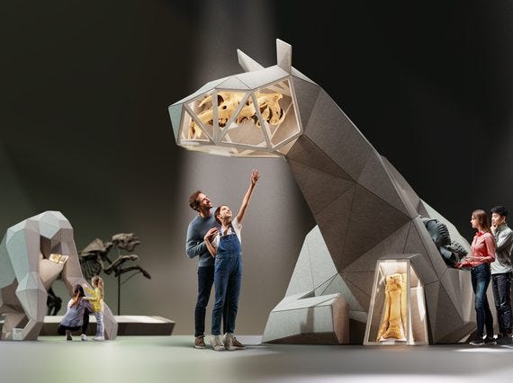 A man and young girl are standing in the centre of the image, pointing upwards at a giant, 3D sculpture of an animal. Other visitors are to the left and right, looking at the same sculpture, and the sculpture of a gorilla to the left