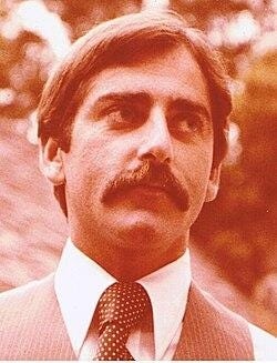 A person with a mustache and a tie

AI-generated content may be incorrect.