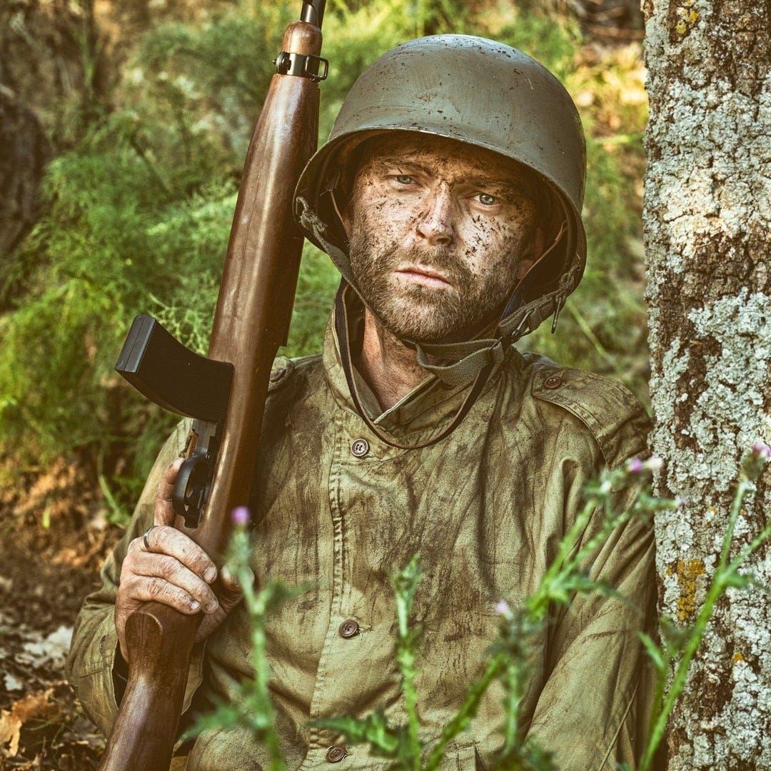 a man in a helmet holding a rifle