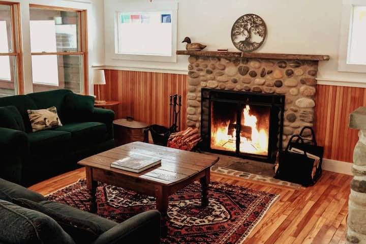 View of the living room and fireplace built by a local mason. View of the living room and fireplace built by a local mason.