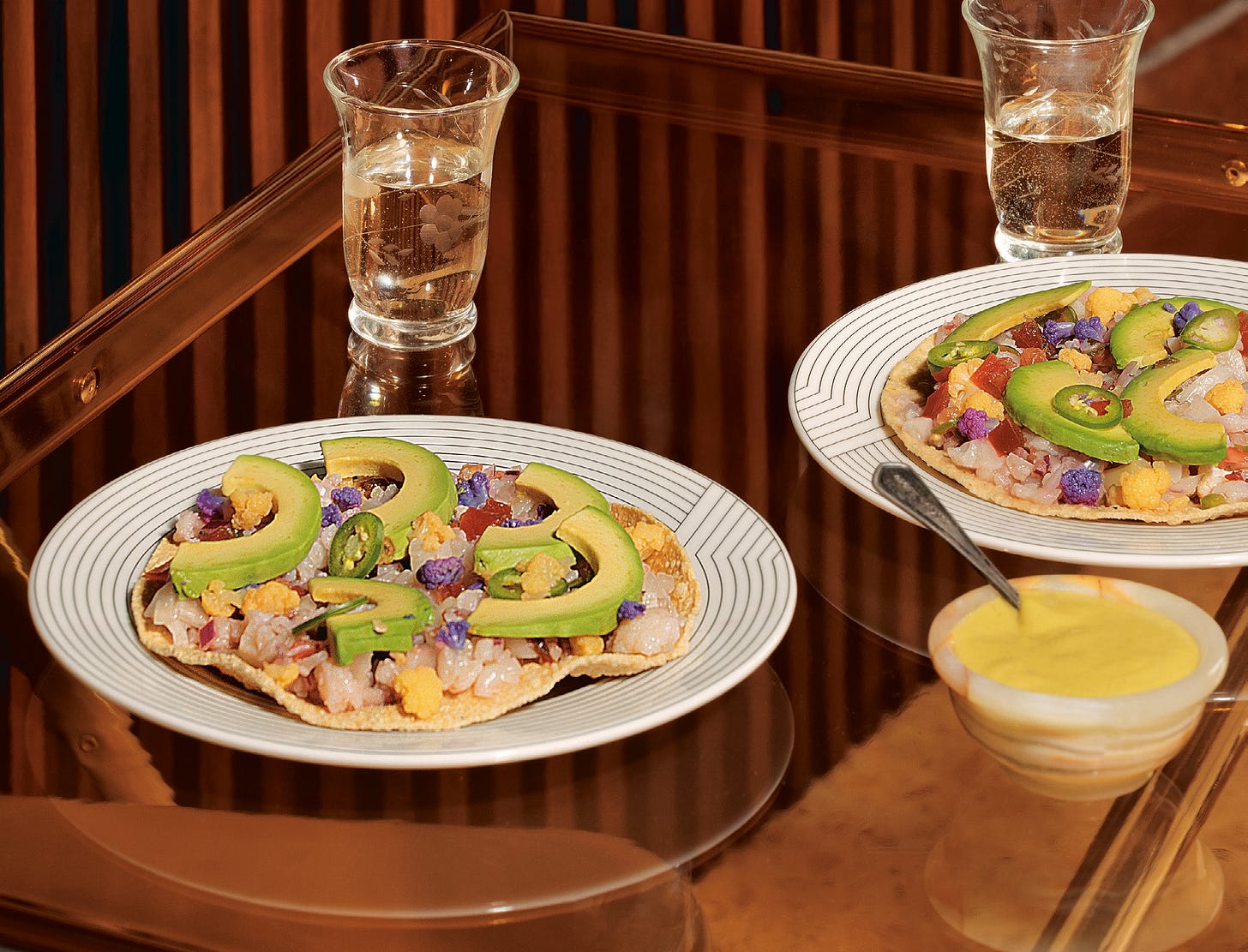 Cauliflower ceviche recipe from Vitamina T, shown on two plates with avocado.