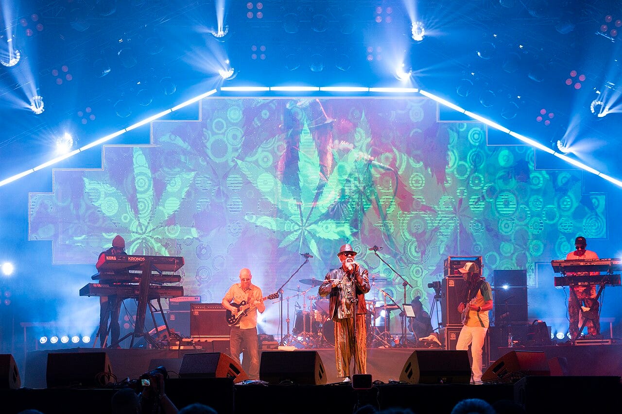 Photo: Krzysztof Popławski / Wikimedia Commons (CC BY-SA 4.0) Ijahman Levi performing on the Red Stage during Ostróda Reggae Festival 2025 in Ostróda , Warmian-Masurian Voivodeship , Poland , on 25 July 2025. The photograph shows a concert stage with the vocalist in the centre, the instrumental band, guitarists
