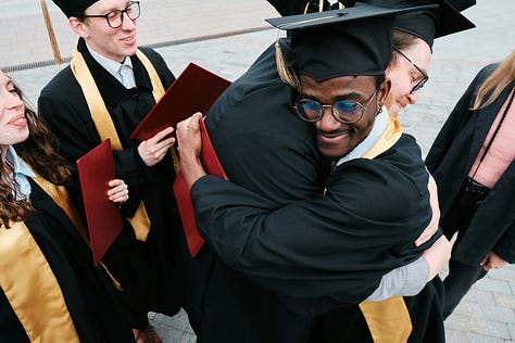 man and woman on a boat on the water with wind blowing, white two-story home with sold sign in front yard, students in regalia hugging after graduation