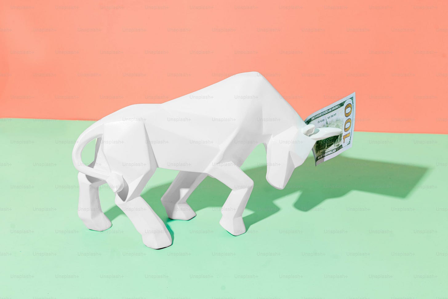 a paper mache of a white bull on a green and pink background
