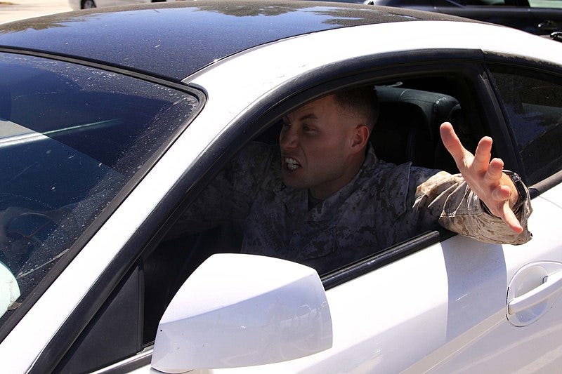 A man in a white car experiences road rage A man in a white car experiences road rage