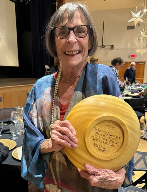 three women holding plaques they received