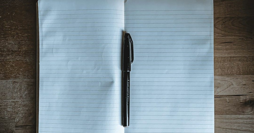 black click pen on white notebook black click pen on white notebook