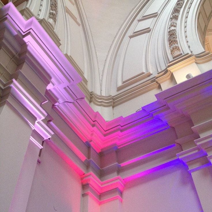 This may contain: the interior of a building with colorful lighting