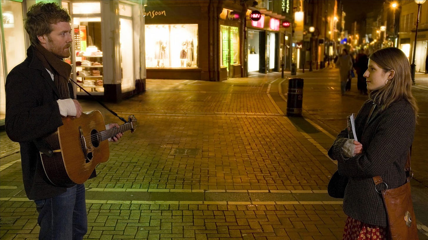 Still from Once that shows Glen Hansard and Marketa Irglova standing on Grafton Street at night