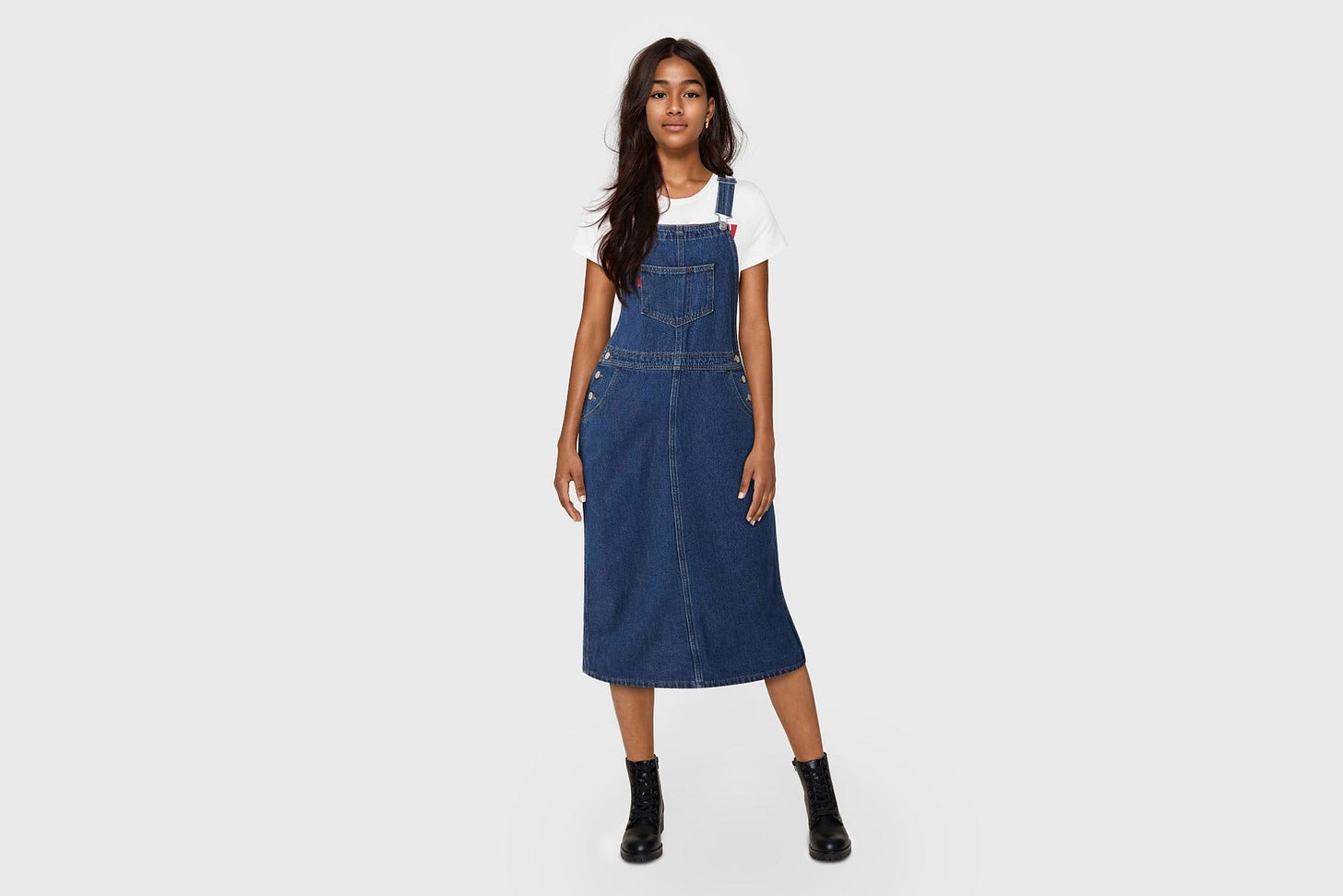 An AI-generated clothing model wearing a denim pinafore dress.